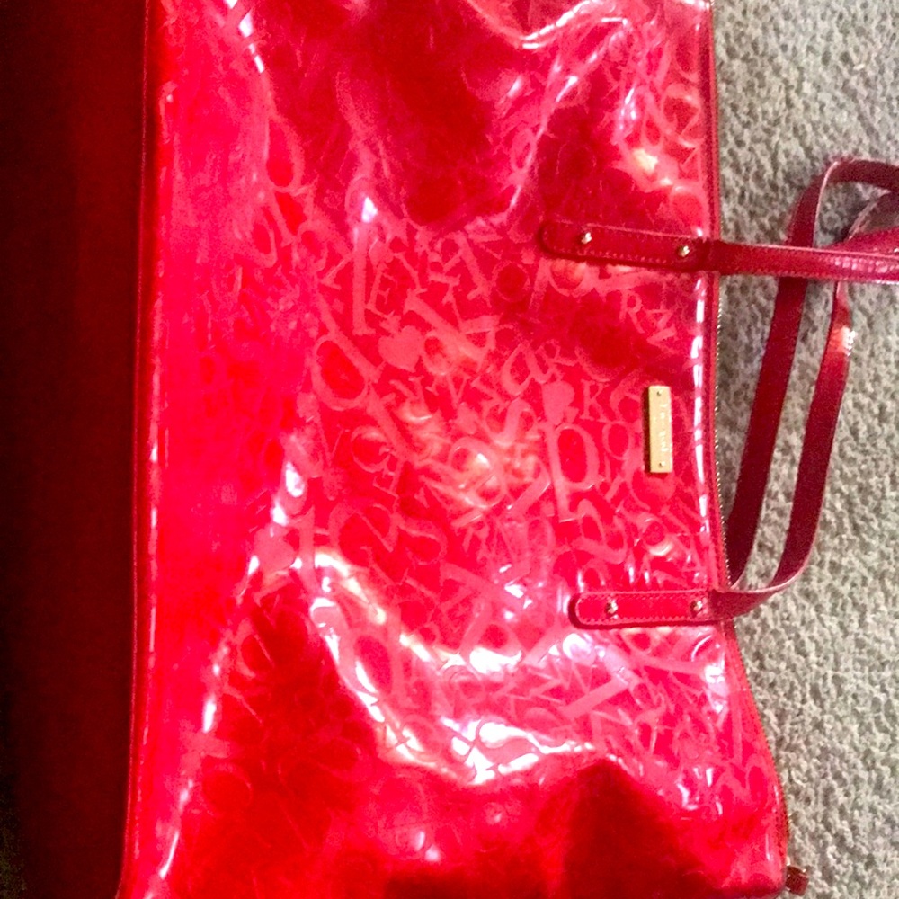 This a red shoulder Kate spade bag worn little wear and tear on the straps